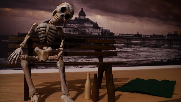 Skeleton, bench, bottles, pier & blanket