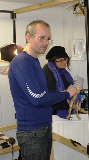 Jacket on - jacket off - not an easy job for Tony, as hands have to be cut off and shoulder strings removed!